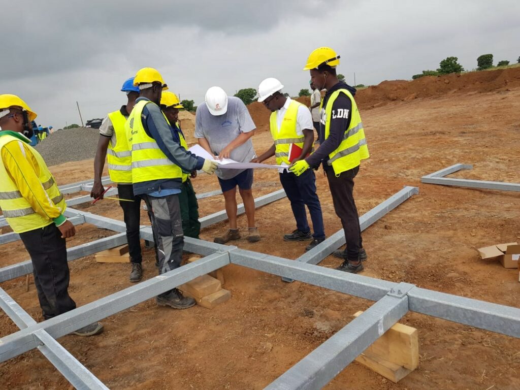 Supervisor guiding local workers on-site for turnkey agricultural installation project by Dutch Farm Design